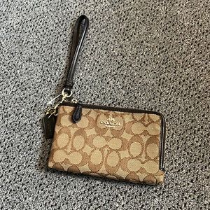 Never used wristlet by Coach. Brown.